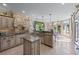 Spacious kitchen with granite countertops, central island, stainless steel appliances, and view of the backyard at 9325 Saint Georgen Cmn, Duluth, GA 30097