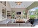 Spacious living room with fireplace, clerestory windows, and views of the backyard at 9325 Saint Georgen Cmn, Duluth, GA 30097