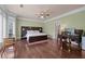Spacious main bedroom with hardwood flooring, light green walls, and bay windows at 9325 Saint Georgen Cmn, Duluth, GA 30097
