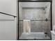 Shower with a glass door, tiled walls, and a mounted shower head at 9325 Saint Georgen Cmn, Duluth, GA 30097