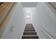 Carpeted staircase with a handrail at 9325 Saint Georgen Cmn, Duluth, GA 30097