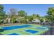 Active community tennis courts with well-maintained surfaces surrounded by lush trees at 9325 Saint Georgen Cmn, Duluth, GA 30097