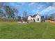 Large backyard features a patio with chairs, a fire pit, and lots of green space to enjoy at 1774 Vesta Ave, Atlanta, GA 30337