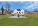 Green backyard features a patio with a fire pit and chairs to enjoy backyard gatherings at 1774 Vesta Ave, Atlanta, GA 30337