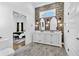 Stunning bathroom with double vanity, decorative wallpaper, and a view into the Primary bedroom at 1774 Vesta Ave, Atlanta, GA 30337
