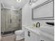 Modern bathroom features a sleek glass shower, contemporary fixtures, and ample storage at 1774 Vesta Ave, Atlanta, GA 30337