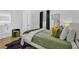 Cozy bedroom with hardwood floors, a comfortable bed and stylish accents at 1774 Vesta Ave, Atlanta, GA 30337