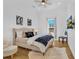 Bright bedroom with hardwood floors, comfortable seating, and a large window offering natural light at 1774 Vesta Ave, Atlanta, GA 30337