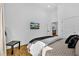 Cozy bedroom featuring hardwood floors, a mounted television, and bright natural lighting at 1774 Vesta Ave, Atlanta, GA 30337