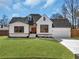 Charming home with a well-kept lawn, a brick facade, and modern design elements at 1774 Vesta Ave, Atlanta, GA 30337
