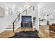 Inviting foyer with a modern staircase, stylish console, and hardwood floors at 1774 Vesta Ave, Atlanta, GA 30337