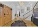 Grand foyer with an elegant chandelier, hardwood floors, and a stylish staircase at 1774 Vesta Ave, Atlanta, GA 30337
