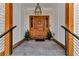 Inviting front entry featuring an ornate wood door, stone flooring and decorative planters at 1774 Vesta Ave, Atlanta, GA 30337