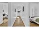 Bright hallway connecting bedrooms, with hardwood floors and natural lighting at 1774 Vesta Ave, Atlanta, GA 30337