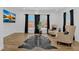 Bright living room featuring hardwood floors, large windows, and neutral armchairs at 1774 Vesta Ave, Atlanta, GA 30337