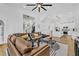 Open concept living space featuring hardwood floors, a modern staircase and an adjacent kitchen at 1774 Vesta Ave, Atlanta, GA 30337