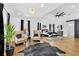 Spacious main bedroom featuring hardwood floors, a seating area, and modern light fixture at 1774 Vesta Ave, Atlanta, GA 30337