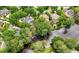 Aerial view of several homes nestled among lush greenery, backing onto a serene lake at 2743 Long Grove Dr, Marietta, GA 30062