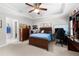 Comfortable bedroom with wooden furniture, a ceiling fan, and a dedicated workspace at 2743 Long Grove Dr, Marietta, GA 30062