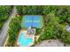 Aerial shot of a community pool, tennis courts, and clubhouse nestled amongst lush trees, providing resort-style living at 2743 Long Grove Dr, Marietta, GA 30062