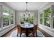 Sun-filled dining room with a round table, wicker chairs, hardwood floors, and large windows showcasing the outdoor scenery at 2743 Long Grove Dr, Marietta, GA 30062