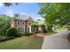 Elegant brick home featuring a well-manicured lawn and a curved driveway leading to the entrance at 2743 Long Grove Dr, Marietta, GA 30062