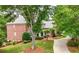Beautiful brick home with a well-manicured lawn, mature trees, and a charming driveway, offering great curb appeal at 2743 Long Grove Dr, Marietta, GA 30062