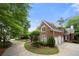 Charming brick home with a three-car garage, well-maintained landscaping, and a circular driveway, exuding classic elegance at 2743 Long Grove Dr, Marietta, GA 30062