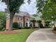 Elegant two-story brick home with lush landscaping and a winding driveway at 2743 Long Grove Dr, Marietta, GA 30062