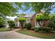 Beautiful two-story red brick home with a well-manicured lawn and mature trees at 2743 Long Grove Dr, Marietta, GA 30062