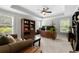 Inviting home office featuring hardwood floors, a ceiling fan, custom wood desk, and natural light at 2743 Long Grove Dr, Marietta, GA 30062