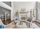 Elegant living room boasts high ceilings, a fireplace, and tufted ottomans for added luxury at 2743 Long Grove Dr, Marietta, GA 30062