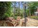 Outdoor patio with stone flooring and wicker furniture, surrounded by lush greenery and a tranquil pond view at 2743 Long Grove Dr, Marietta, GA 30062