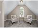 Finished attic space featuring two chairs, carpet and natural light at 4648 Glenshire Pl, Atlanta, GA 30338