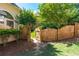 A wooden gate provides backyard access and is surrounded by greenery and shrubbery at 4648 Glenshire Pl, Atlanta, GA 30338