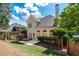 A spacious backyard is shown, with a patio seating area, lush green grass, and a swing set at 4648 Glenshire Pl, Atlanta, GA 30338