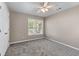 Light filled bedroom features neutral walls, soft carpet, a ceiling fan, and a bright window at 4648 Glenshire Pl, Atlanta, GA 30338