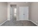 This spacious bedroom features neutral walls, plush carpet, a double closet, and natural light at 4648 Glenshire Pl, Atlanta, GA 30338