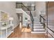 Welcoming foyer with hardwood floors, an elegant staircase with iron railings, and ample natural light at 4648 Glenshire Pl, Atlanta, GA 30338