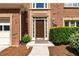 Charming brick home featuring a well-manicured lawn and a front door with sidelights and an address plaque at 4648 Glenshire Pl, Atlanta, GA 30338
