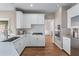 Modern kitchen showcasing stainless appliances, white cabinetry and hardwood flooring at 4648 Glenshire Pl, Atlanta, GA 30338