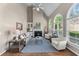 Bright living room featuring vaulted ceiling, fireplace, and an abundance of natural light at 4648 Glenshire Pl, Atlanta, GA 30338