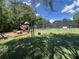 Community playground offers various swings and play equipment, complemented by lush greenery at 4648 Glenshire Pl, Atlanta, GA 30338