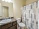 Bathroom featuring a shower with patterned curtain, granite countertop, and neutral color palette at 856 Donington Cir, Lawrenceville, GA 30045