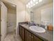 Neutral bathroom with granite countertop vanity, decorative lighting and tub shower at 856 Donington Cir, Lawrenceville, GA 30045