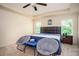 Well-lit bedroom featuring neutral walls, carpet, a tray ceiling, and furnishings at 856 Donington Cir, Lawrenceville, GA 30045
