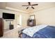Spacious bedroom with ceiling fan, carpet, and mounted television, creating a relaxing retreat at 856 Donington Cir, Lawrenceville, GA 30045