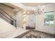 Bright foyer featuring elegant wainscoting, a chandelier, staircase, and views of the front door and dining area at 856 Donington Cir, Lawrenceville, GA 30045