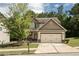 Charming two-story home featuring a two-car garage and a well-manicured front yard with mature landscaping at 856 Donington Cir, Lawrenceville, GA 30045