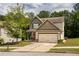 Charming two-story home featuring a two-car garage and a well-manicured front yard with mature landscaping at 856 Donington Cir, Lawrenceville, GA 30045